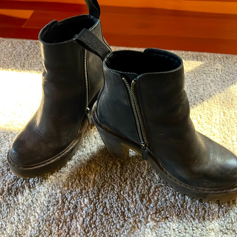 Black leather heeled Doc Marten boots in well loved condition